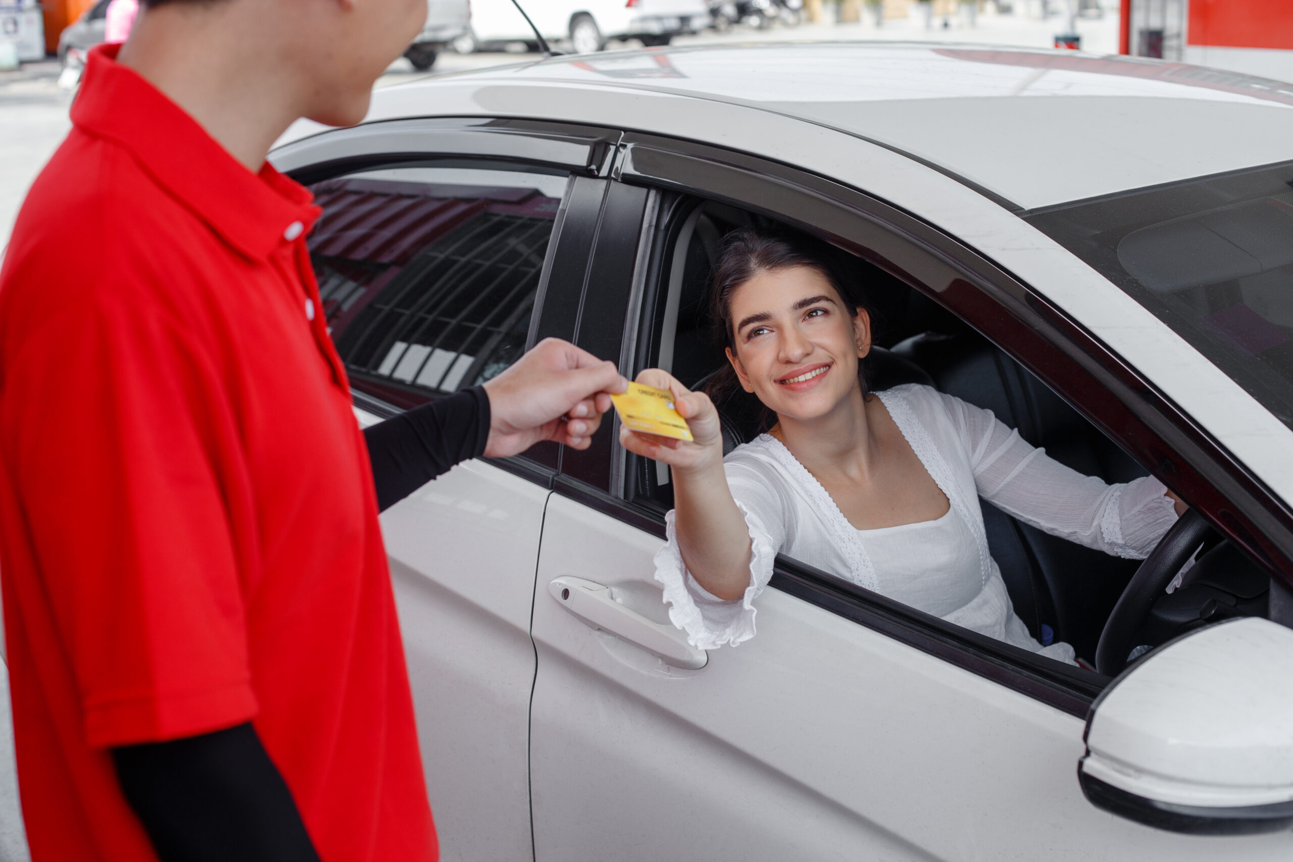 woman-in-car-paying-credit-card-after-refuel-car-2022-12-23-00-52-35-utc-scaled.jpg